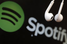 Headphones are seen in front of a logo of online music streaming service Spotify in this illustration picture taken in Strasbourg, February 18, 2014. Spotify is recruiting a U.S. financial reporting specialist, adding to speculation that the Swedish start-up is preparing for a share listing, which one banker said could value the firm at as much as $8 billion. REUTERS/Christian Hartmann (FRANCE - Tags: BUSINESS ENTERTAINMENT LOGO) - RTX1914U