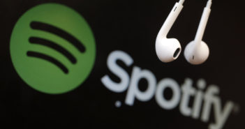 Headphones are seen in front of a logo of online music streaming service Spotify in this illustration picture taken in Strasbourg, February 18, 2014. Spotify is recruiting a U.S. financial reporting specialist, adding to speculation that the Swedish start-up is preparing for a share listing, which one banker said could value the firm at as much as $8 billion. REUTERS/Christian Hartmann (FRANCE - Tags: BUSINESS ENTERTAINMENT LOGO) - RTX1914U